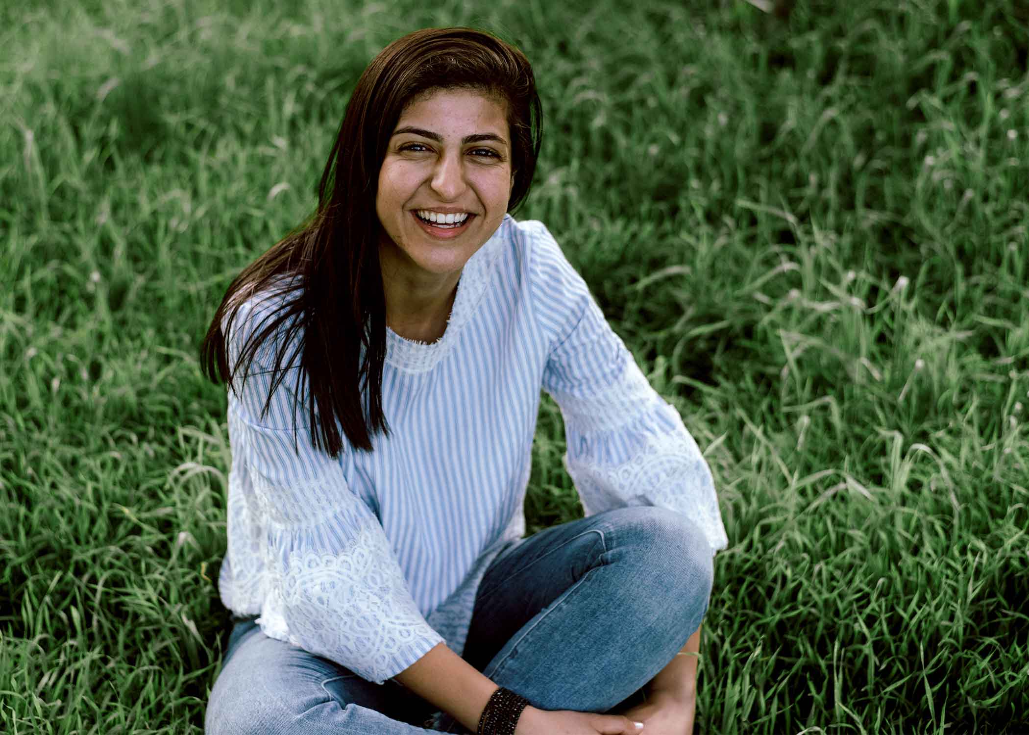 Sherry Saroufeem, a 2019 graduate of Cal Poly, sits and smiles for a photo. 