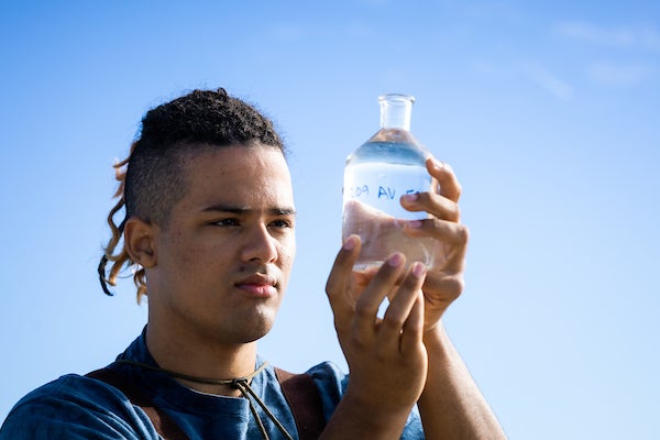 Student Jake Roth inspects a labeled water sample.