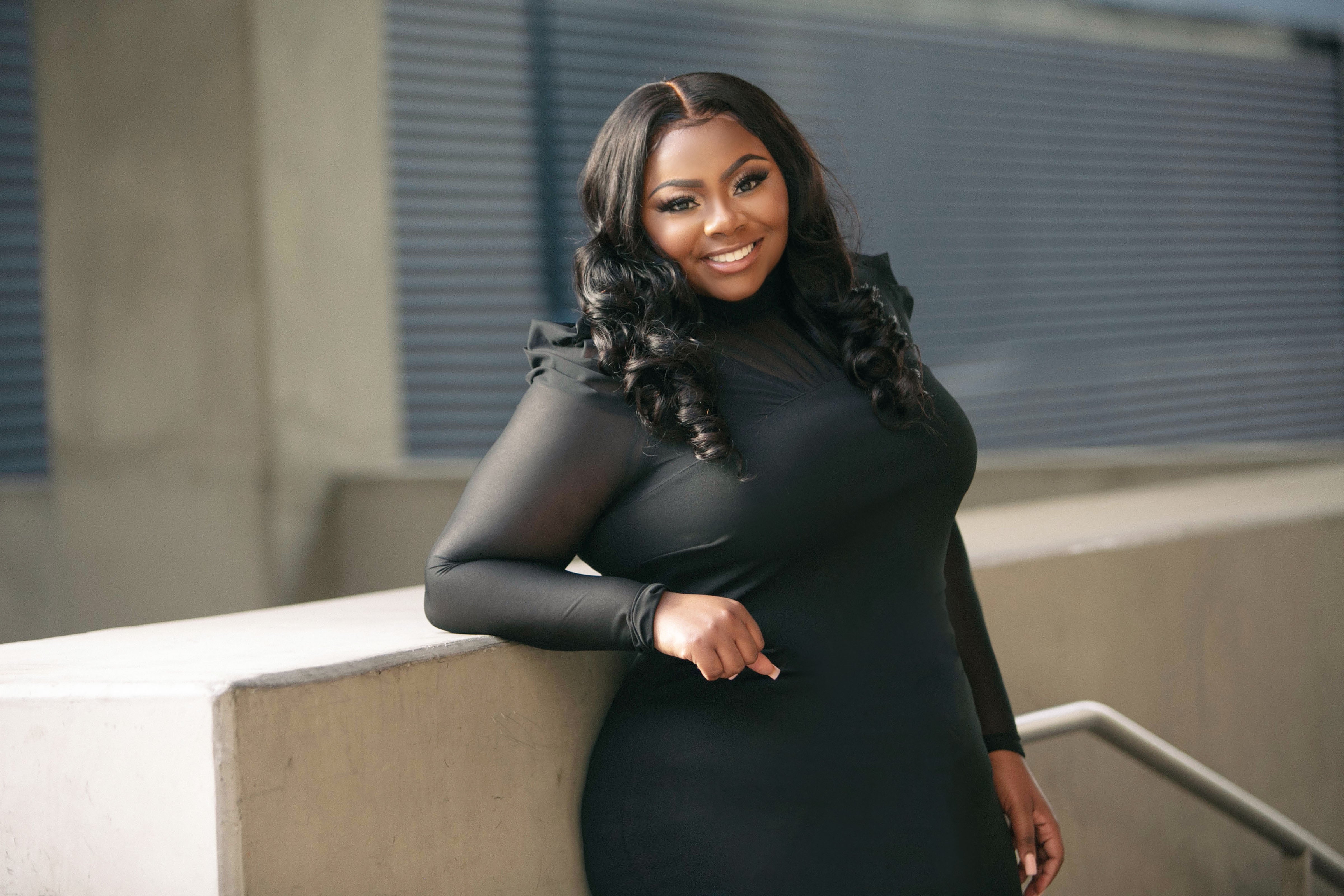 Scholarship recipient Nailah DuBose, smiling in a black dress