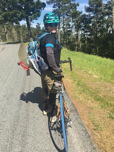  Jenny Phillips bikes into a field site during the shutdown with all recording equipment strapped to her back.