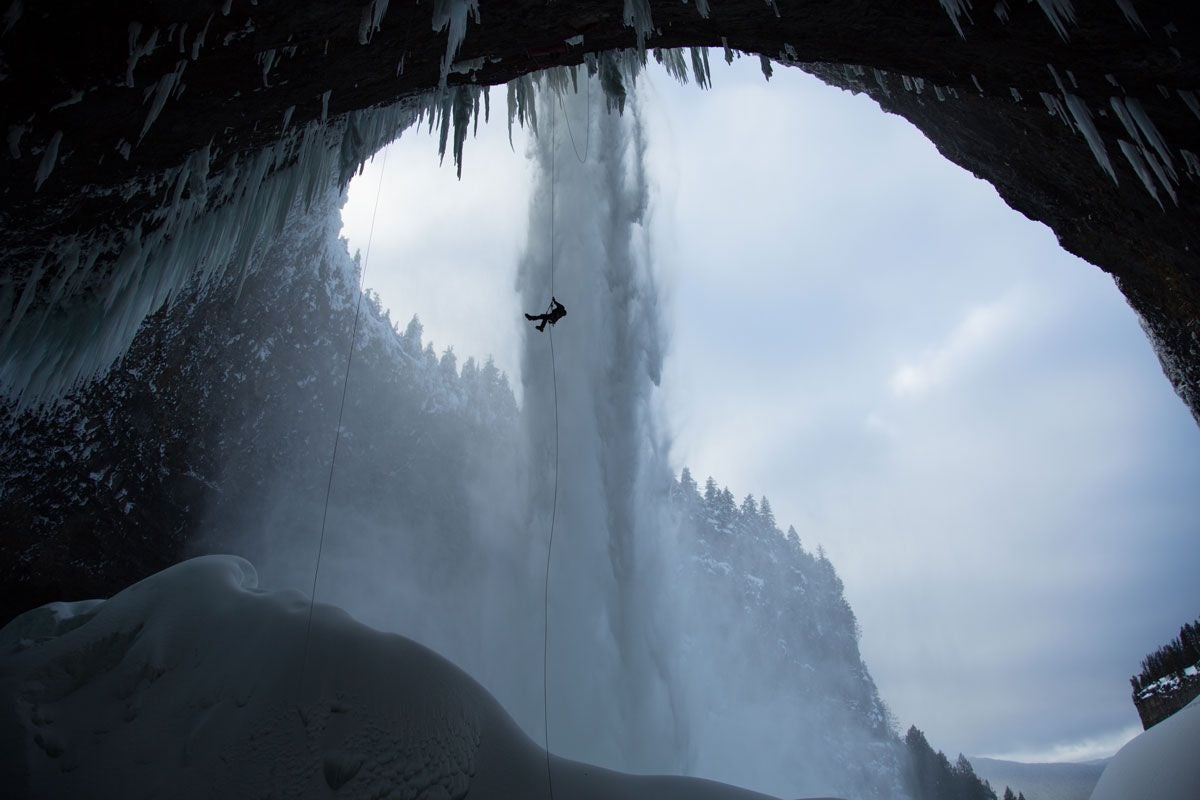 Rappelling Climber over Icy Mountain