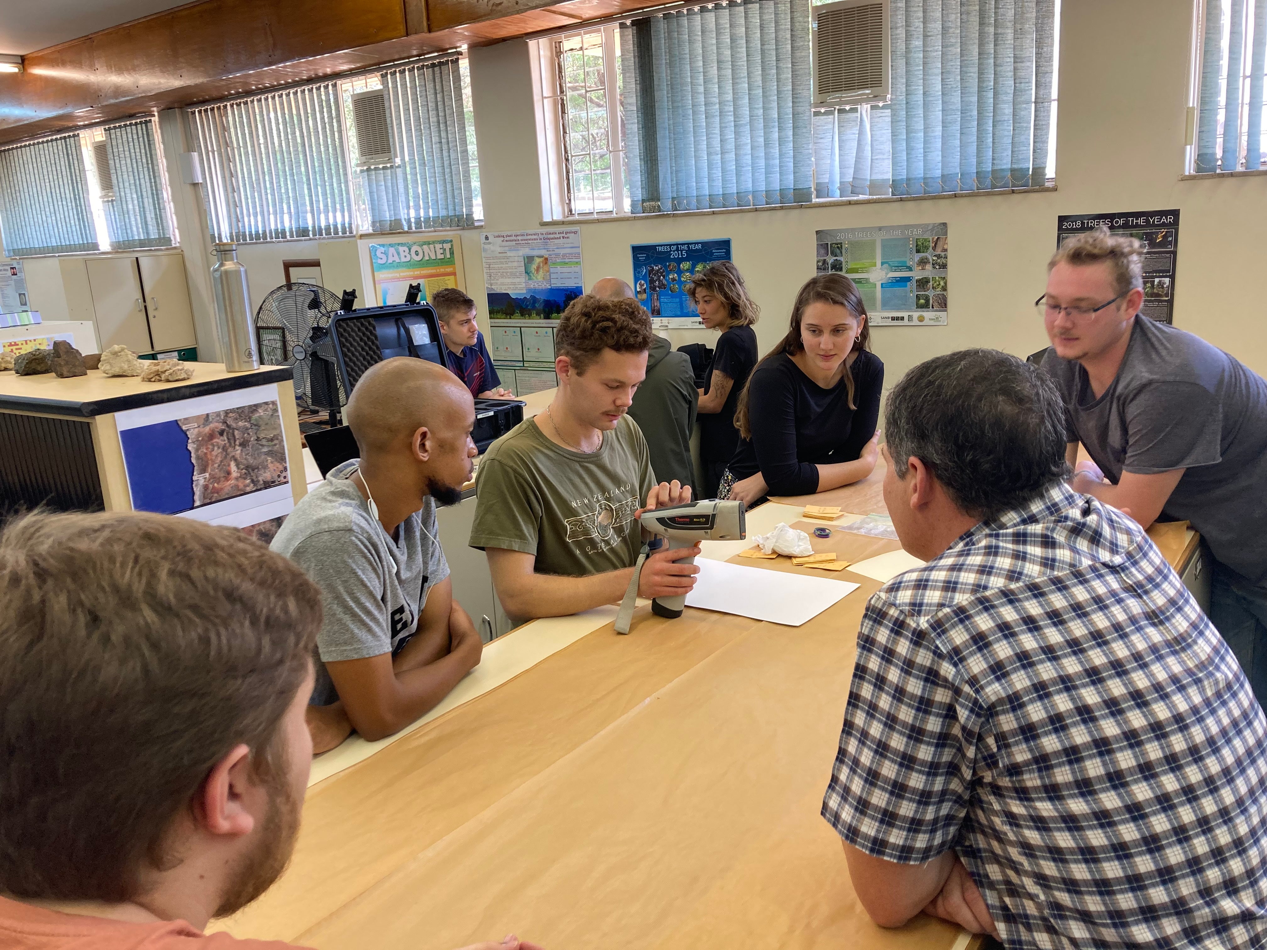 TJ Samojedny demonstrates a portable X-ray fluorescence device to students in South Africa.