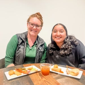 Staff pose as they eat their lunch.