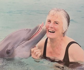 Image of Donna Duerk with a dolphin.