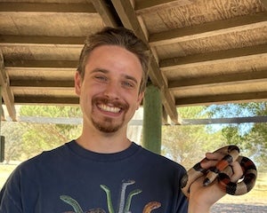 Owen Bachhuber holds a milksnake.