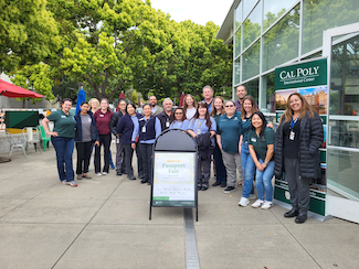 Faculty and staff join in a group photo at the Passport Fair.