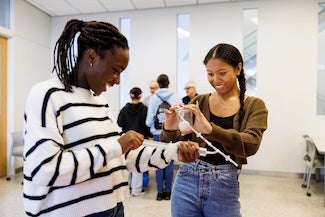 Two students work on a project together.