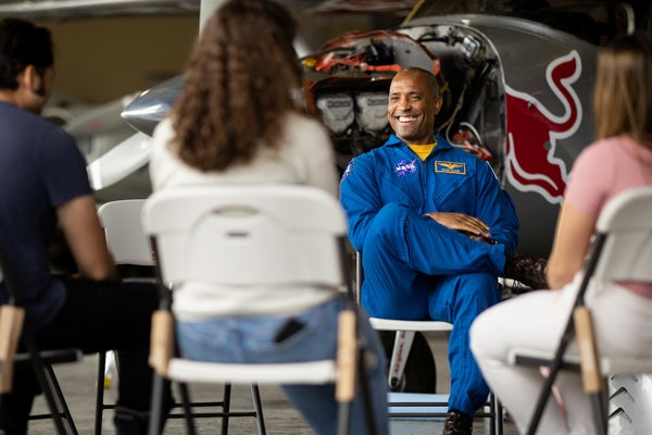 Captain Victor Glover talks with engineering students in a hangar at the SLO Regional Airport