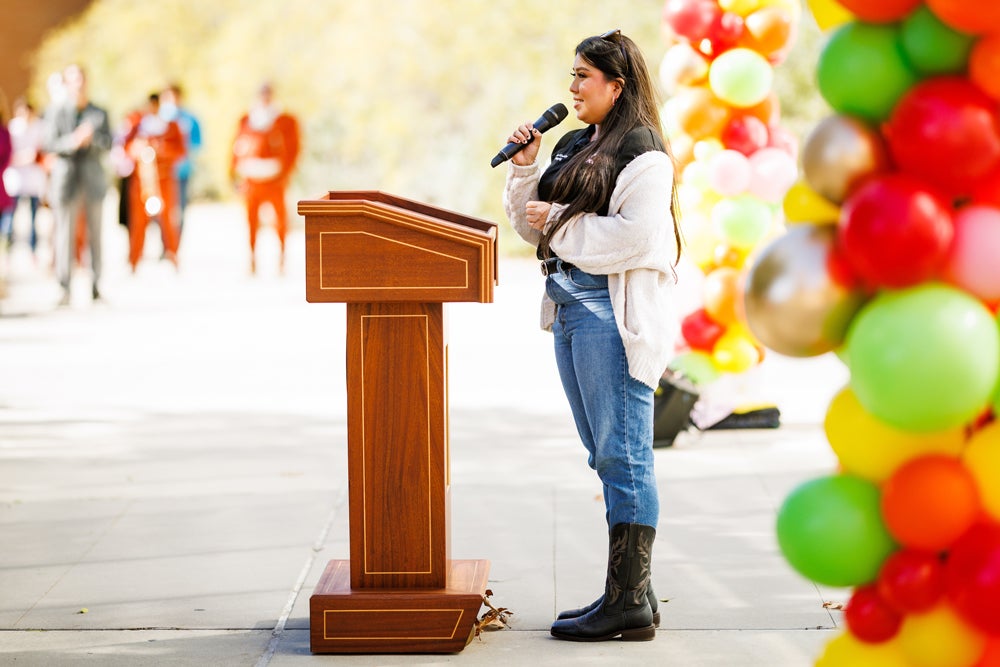 La CASA student leader Griselda Elizabeth Medrano speaks from the podium to the audience at the grand opening