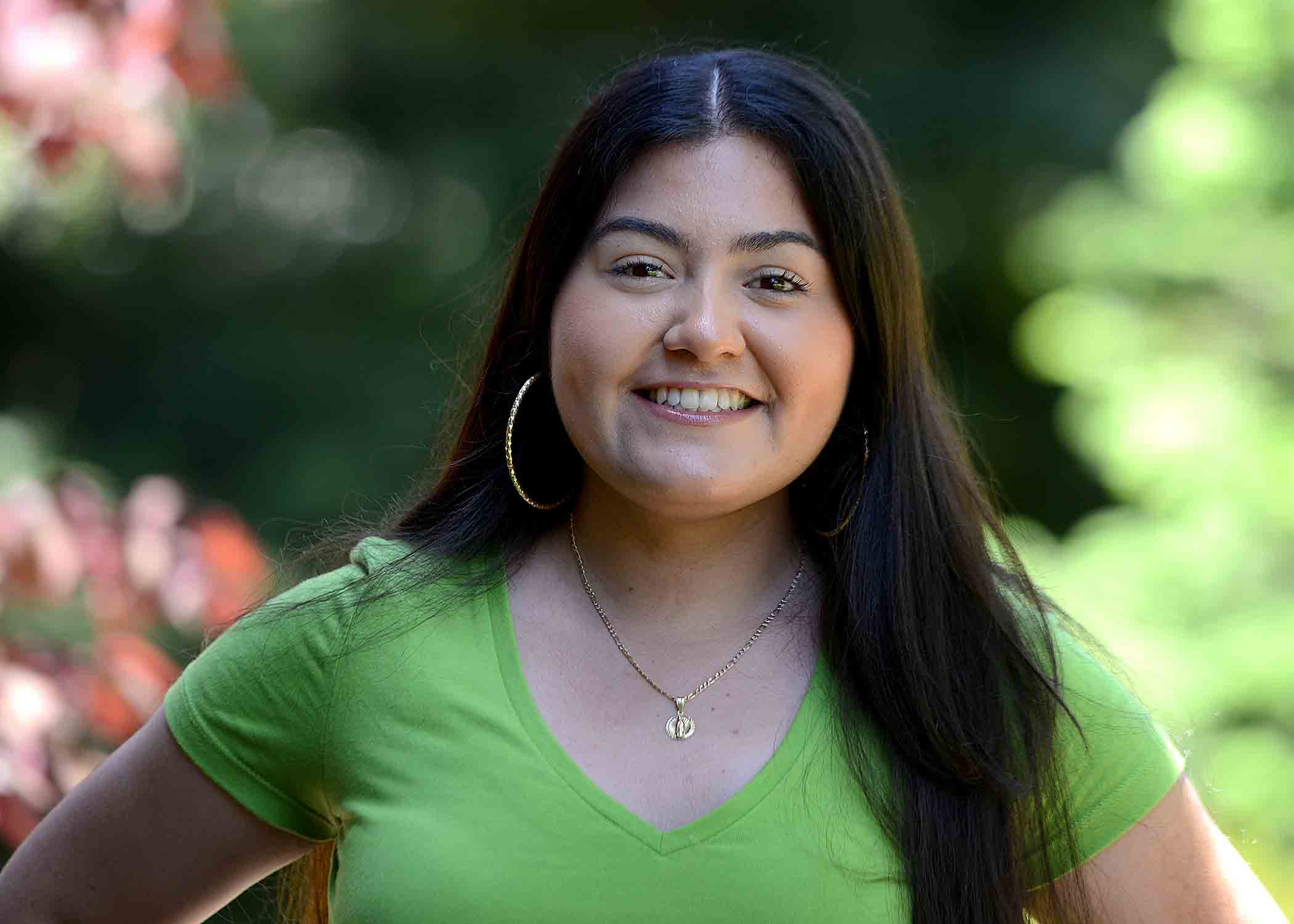 Daniela Ramos smiles in a headshot. She is wearing a green shirt.