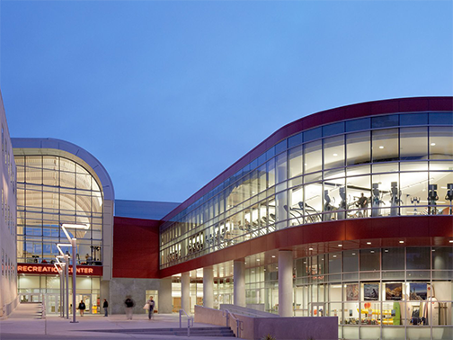 An exterior view of the Cal Poly Recreation Center in the evening.