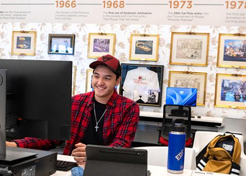 A male student works at a computer at a Kennedy Library temporary site