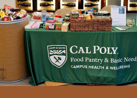 Donations of nonperishiboe food stacked on a table and in a large drum