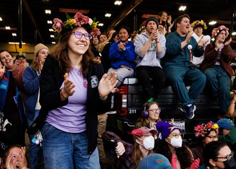 Cal Poly Rose Float President Quinn Akemon applauds with 2024 teammates in Pasadena