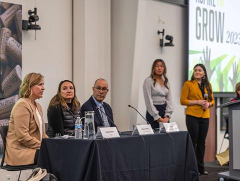 Speakers sit at a table at the 2023 nnual Aspire to Grow Conference