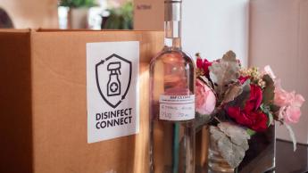 A box labeled Disinfect Connect rests next to a bottle of hand sanitizer.