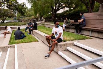 Students wearing face masks and keeping a safe distance on Cal Poly's campus.