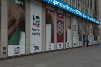 At Fox News headquarters in New York City, signs promote the network's 2020 election coverage with the slogan "America is Watching"