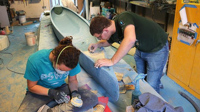 Civil Engineering students working on concrete canoe