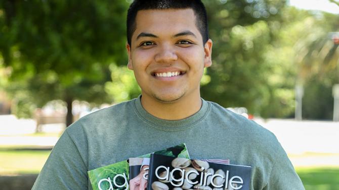 Student with issue of Ag Circle, a student generated magazine published by the Brock Center for Agricultural Communication