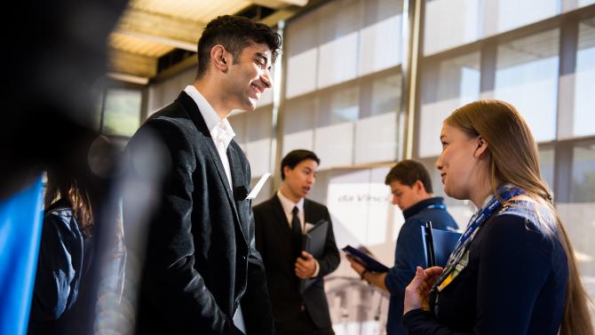 Two students chatting at a job fair