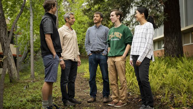 professors and students talk outside