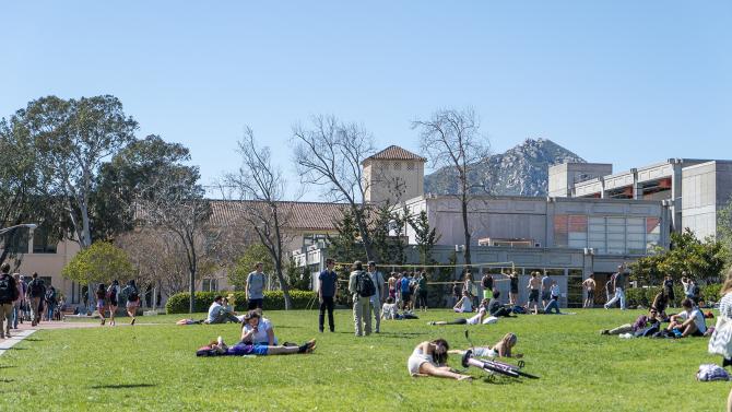 Students relaxing and playing volleyball on Dexter lawn