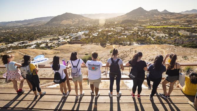 Students at the Cal Poly P looking out over the campus