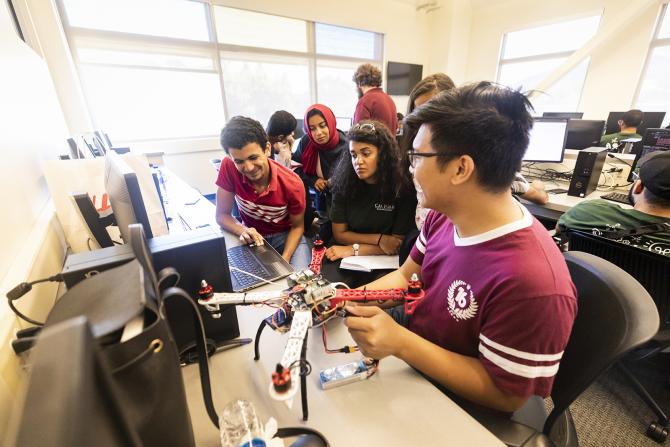 Group of students building a robotic drone. 