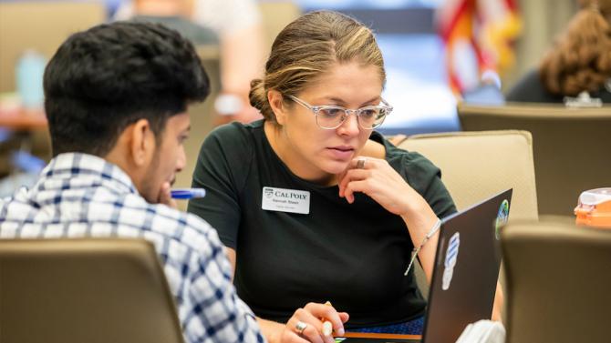 Career Services staff works with a student at a resume clinic