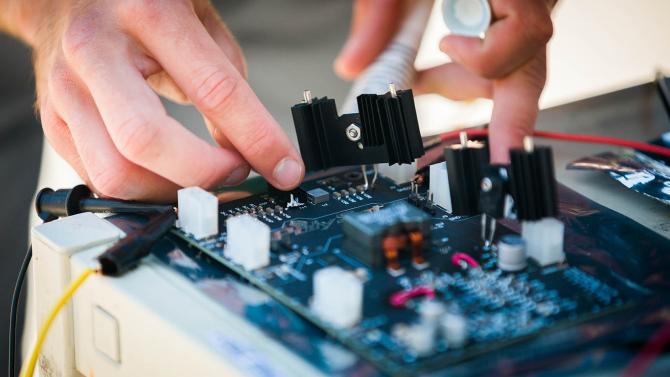 Students works on electrical power system