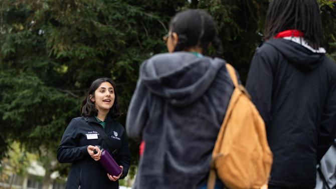 A student tour guide speaks to students.